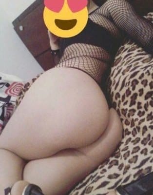 Person lying on a leopard-print bed, wearing fishnet stockings; their face is obscured by a heart-eyes emoji.